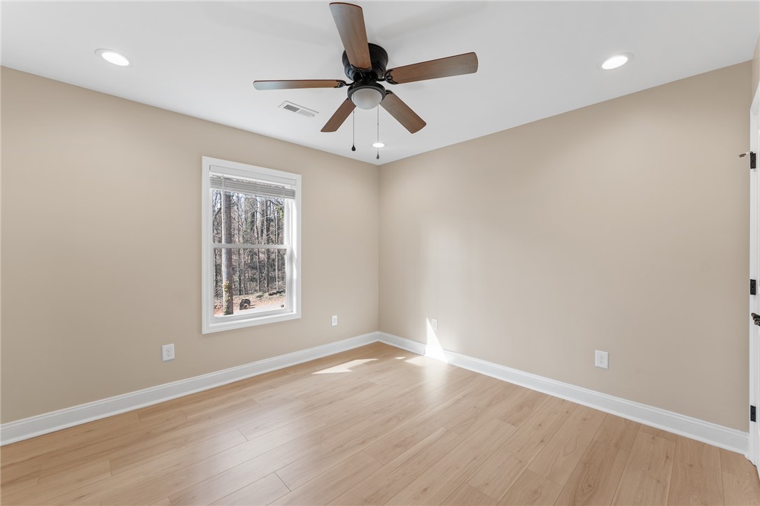 505 Hillside Drive Walhalla, SC 29691 - Photo 20 of 31 This bright room features light flooring, a ceiling fan, and ample natural light from the window.