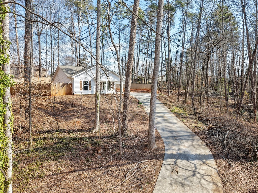 505 Hillside Drive Walhalla, SC 29691 - Photo 2 of 31 A charming residence nestled among natural woodlands, offering a serene and secluded living experience.