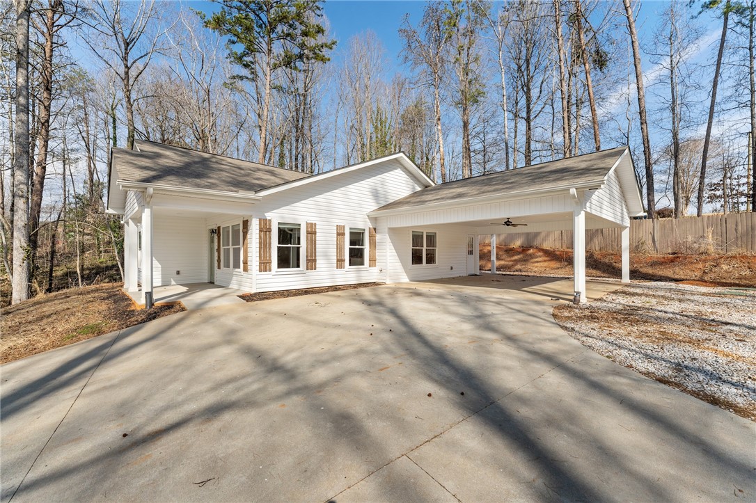 505 Hillside Drive Walhalla, SC 29691 - Photo 4 of 31 This charming home offers a serene woodland setting with convenient covered parking.