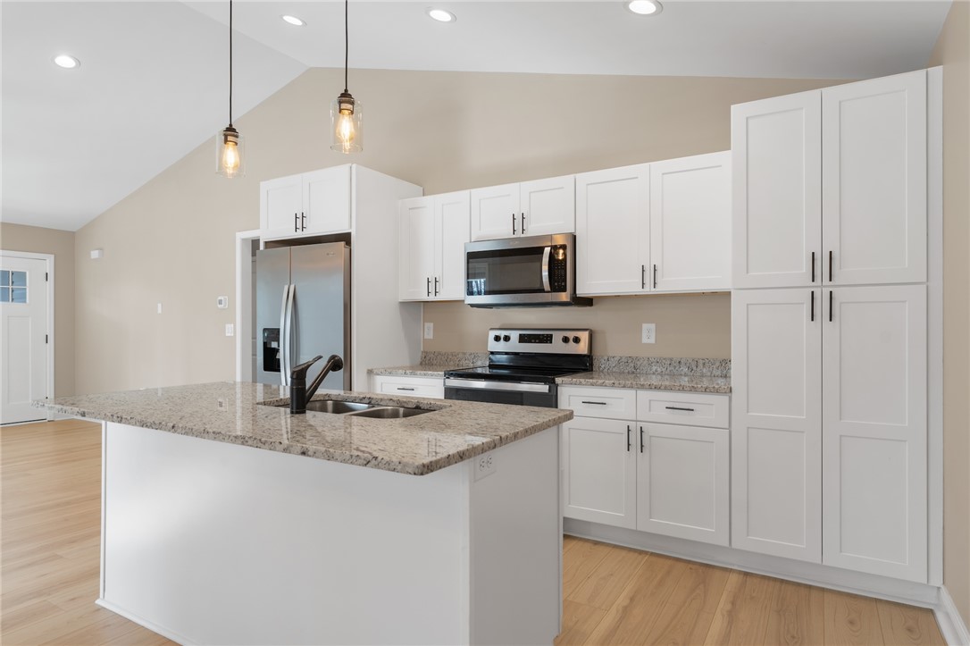 505 Hillside Drive Walhalla, SC 29691 - Photo 10 of 31 This kitchen features a spacious island with a sink, white cabinetry, and modern stainless steel appliances.