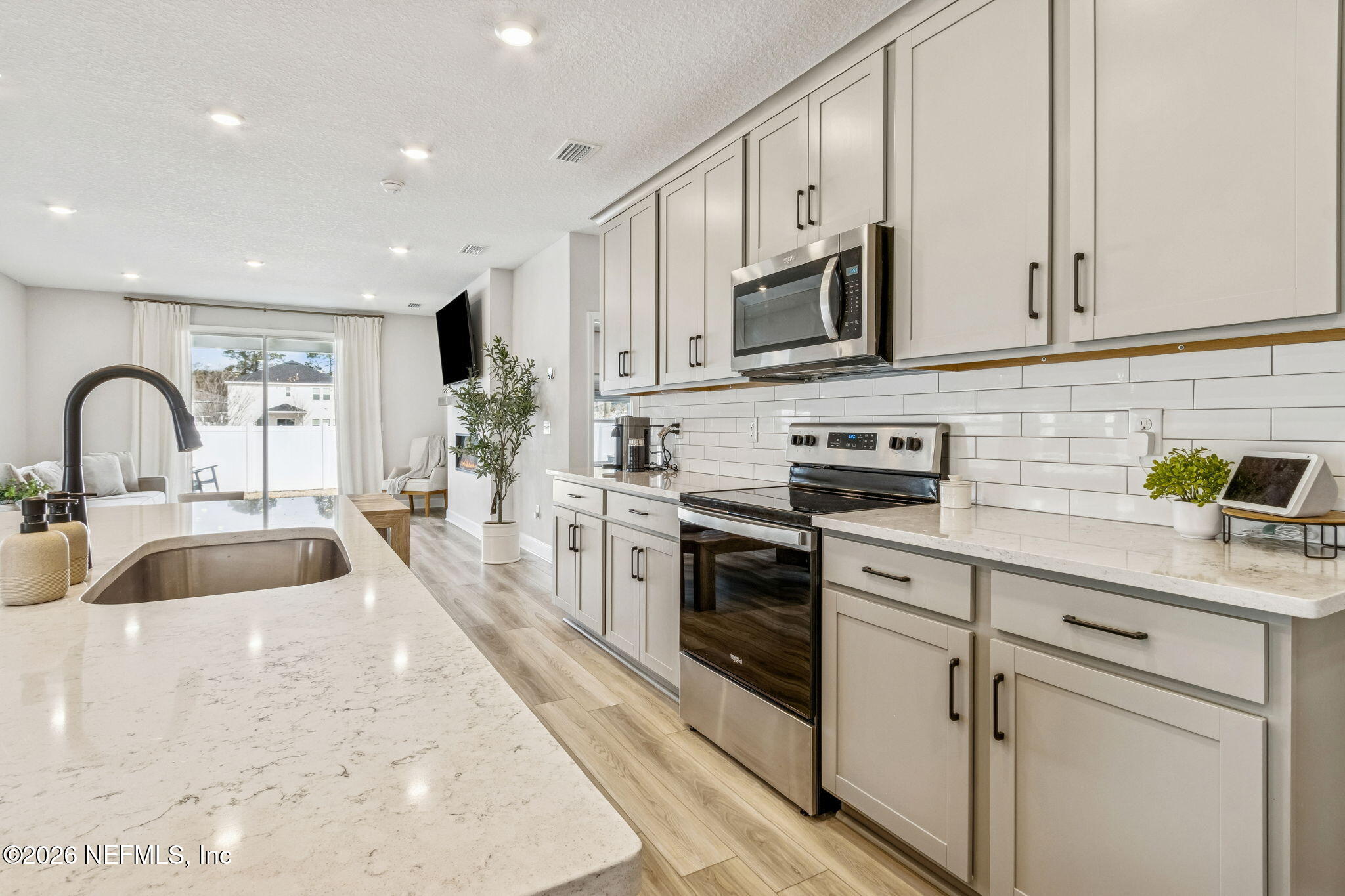 95057 Terris Way Fernandina Beach, FL 32034 - Photo 13 of 43 a kitchen with stainless steel appliances granite countertop a sink a stove and a refrigerator
