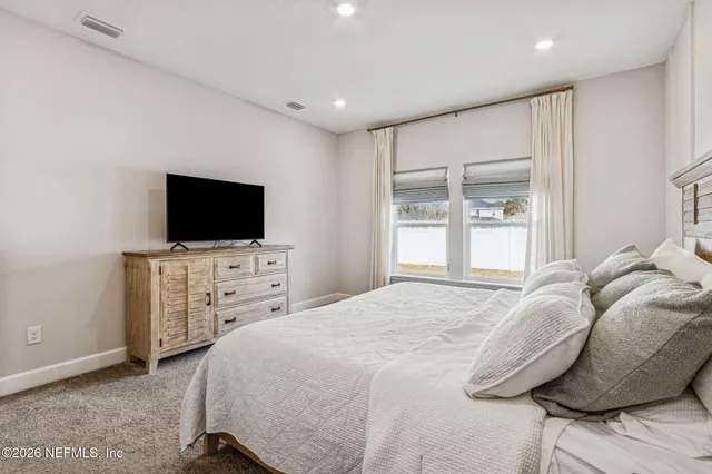 a large bed sitting in a bedroom and table