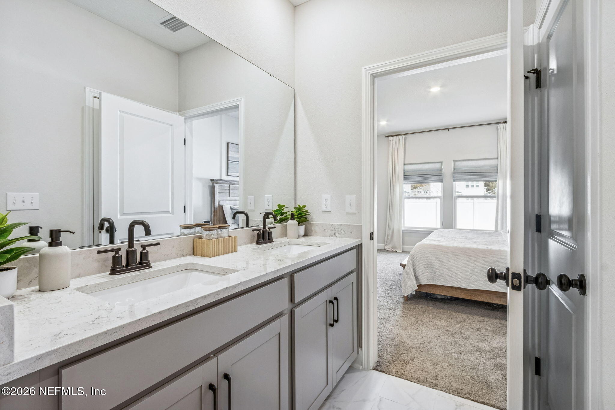 95057 Terris Way Fernandina Beach, FL 32034 - Photo 21 of 43 a en suite bathroom with a granite countertop sink and a mirror