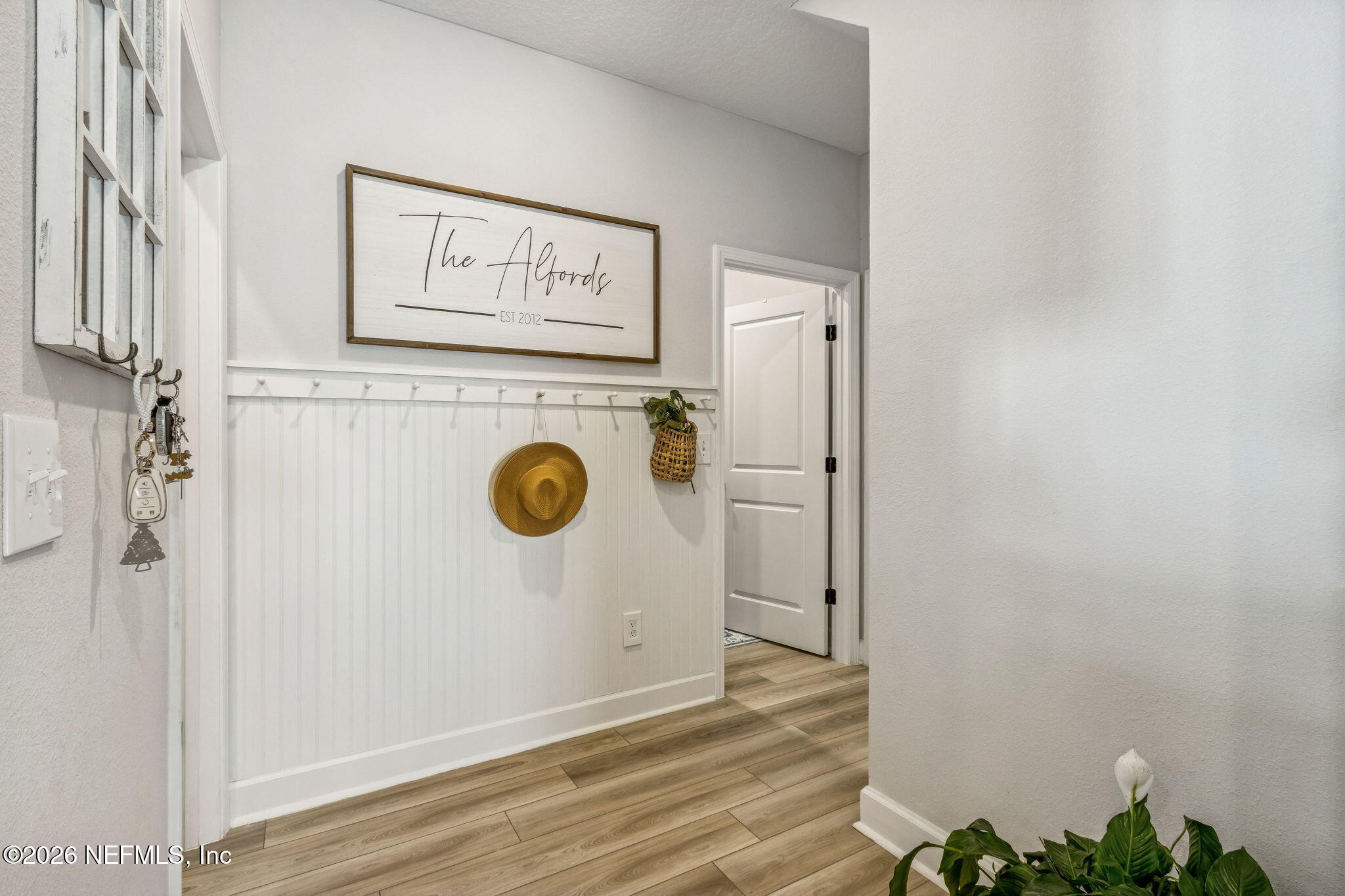 95057 Terris Way Fernandina Beach, FL 32034 - Photo 23 of 43 a view of a hallway with wooden floor and a bathroom view