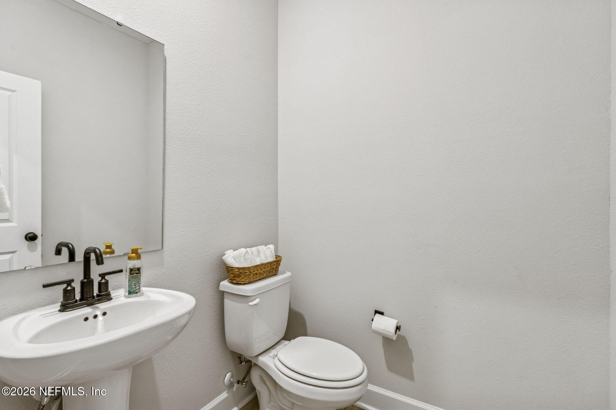 95057 Terris Way Fernandina Beach, FL 32034 - Photo 24 of 43 a bathroom with a sink a toilet and a mirror