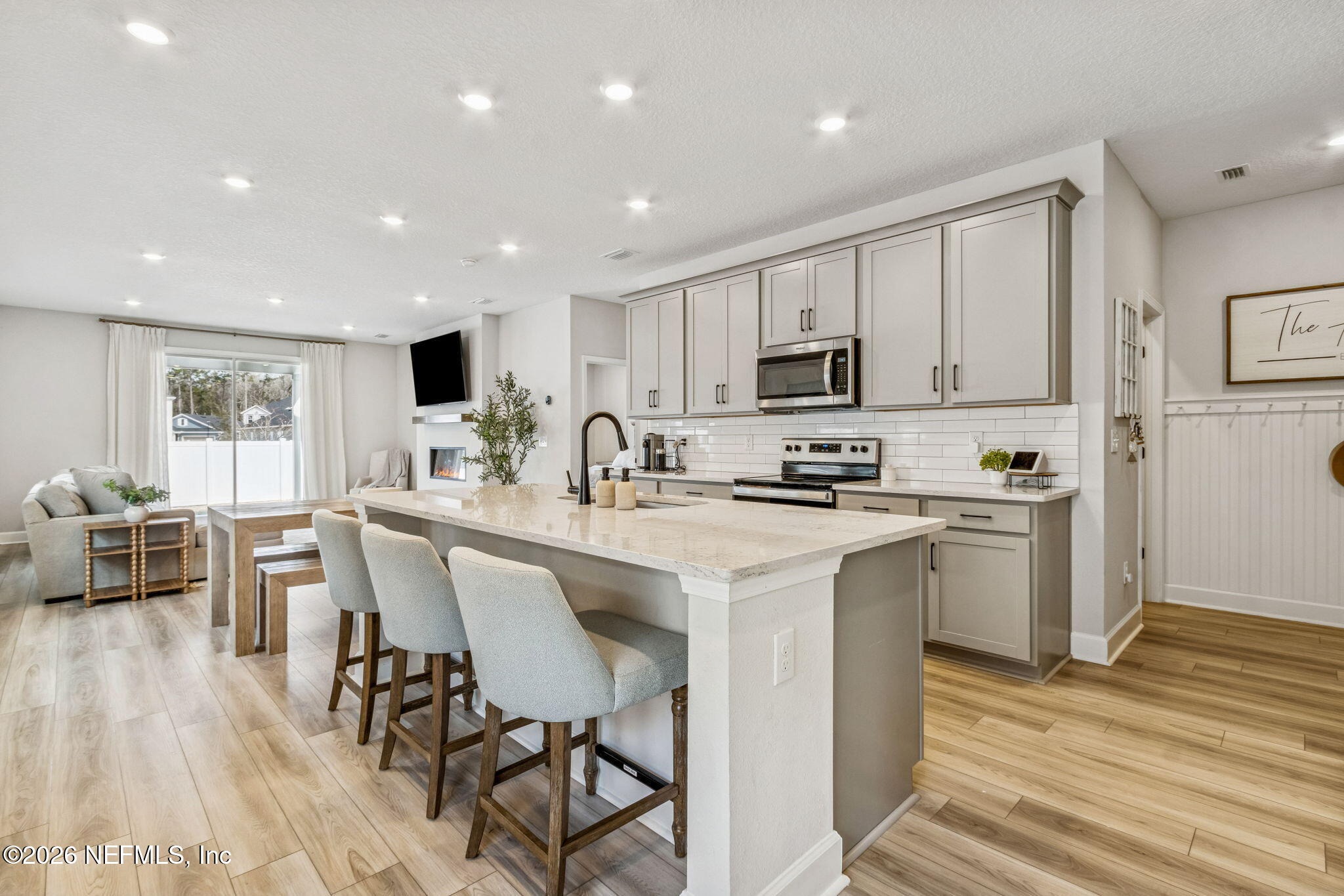 95057 Terris Way Fernandina Beach, FL 32034 - Photo 3 of 43 a kitchen with white cabinets stainless steel appliances and kitchen island