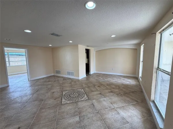 a view of livingroom with an empty space and a window