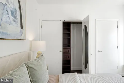 a bedroom with a bed and a wall painting