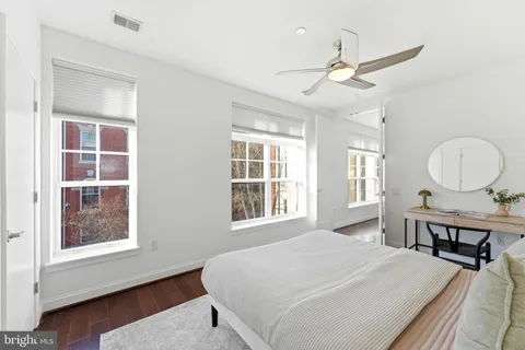 a bed room with a bed mirror and a window