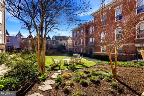a view of swimming pool with a house in the background