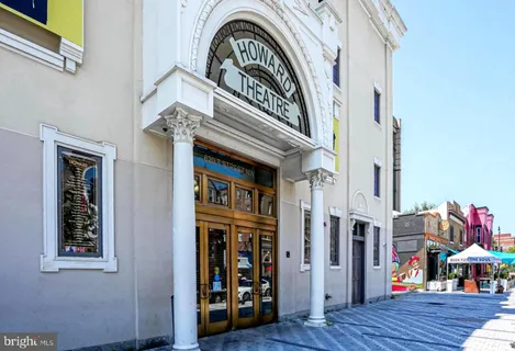 a view of living room and hallway with wooden floor