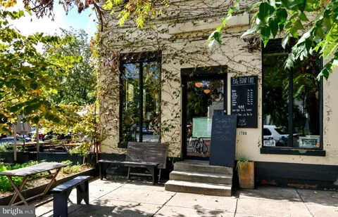 a front view of a building with outdoor seating