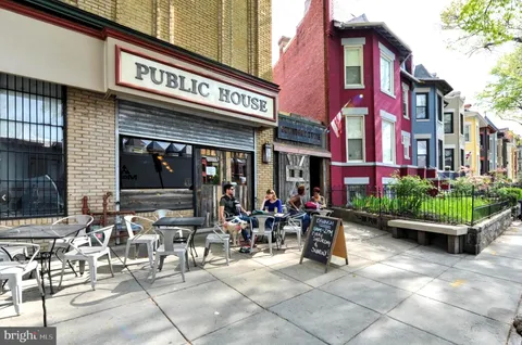 a group of people sitting in front of cafe