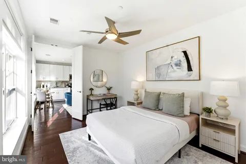 a bedroom with a bed and wooden floor