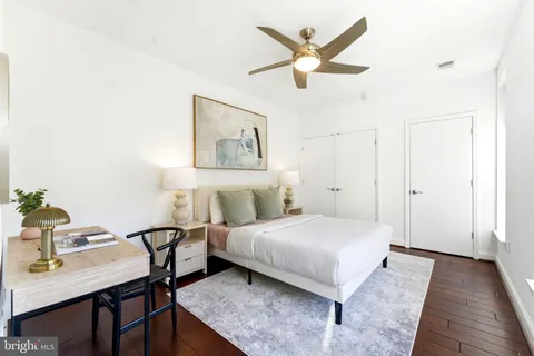 a bedroom with a bed and a table in it