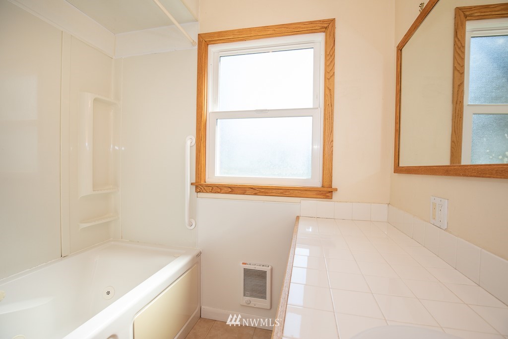 19528 Tualco Loop Road Monroe, WA 98272 - Photo 14 of 24 a bathroom with a bathtub and a window