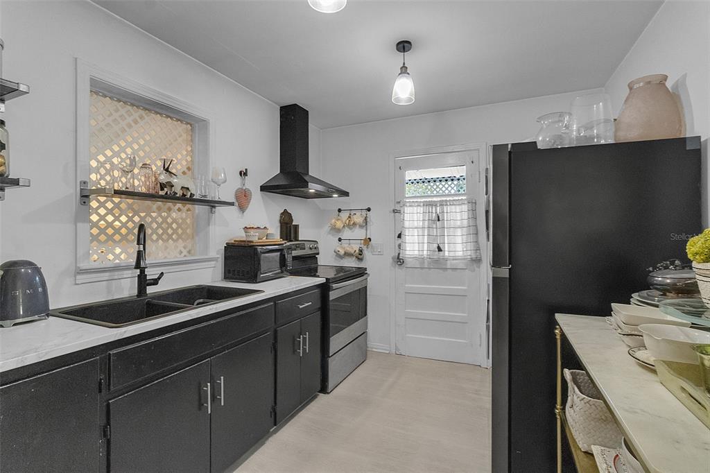 2562 Ashton Road Sarasota, FL 34231 - Photo 14 of 30 a kitchen with a sink stove and refrigerator