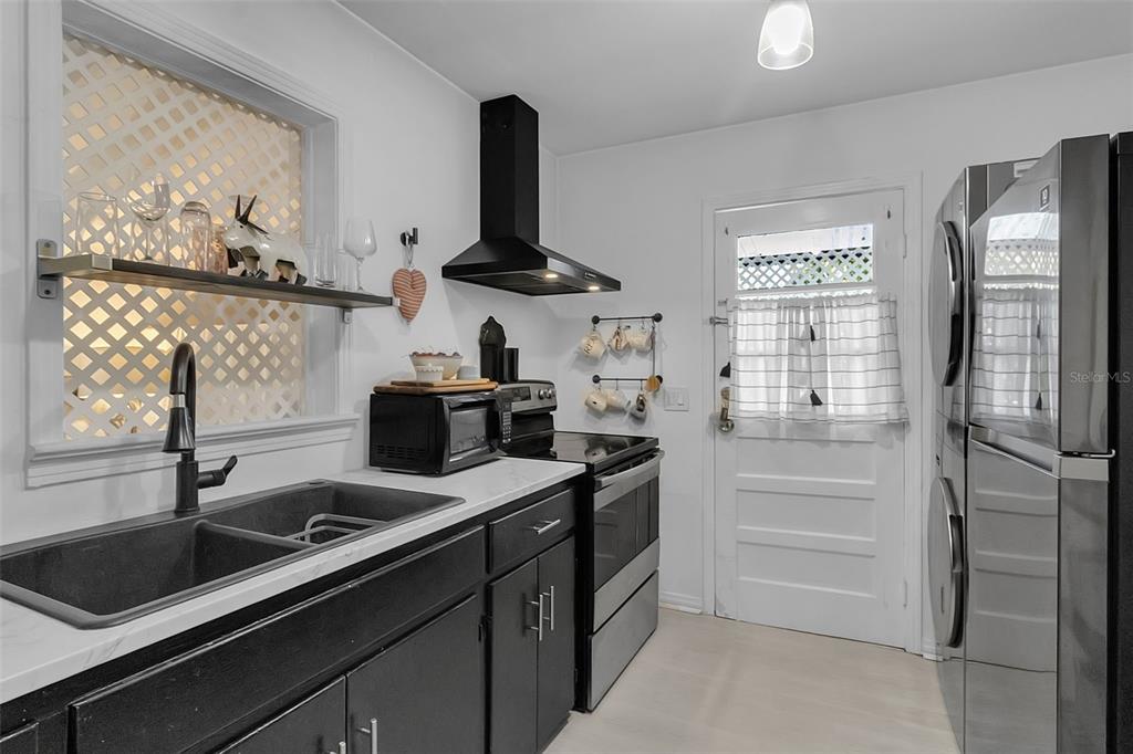 2562 Ashton Road Sarasota, FL 34231 - Photo 15 of 30 a kitchen with a sink cabinets and window
