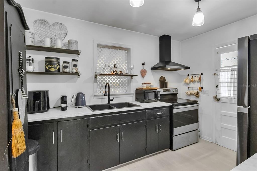 2562 Ashton Road Sarasota, FL 34231 - Photo 16 of 30 a kitchen with stainless steel appliances a sink and cabinets