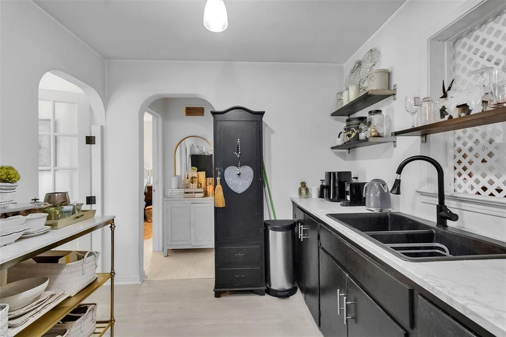 2562 Ashton Road Sarasota, FL 34231 - Photo 17 of 30 a kitchen with stainless steel appliances granite countertop a sink stove and refrigerator