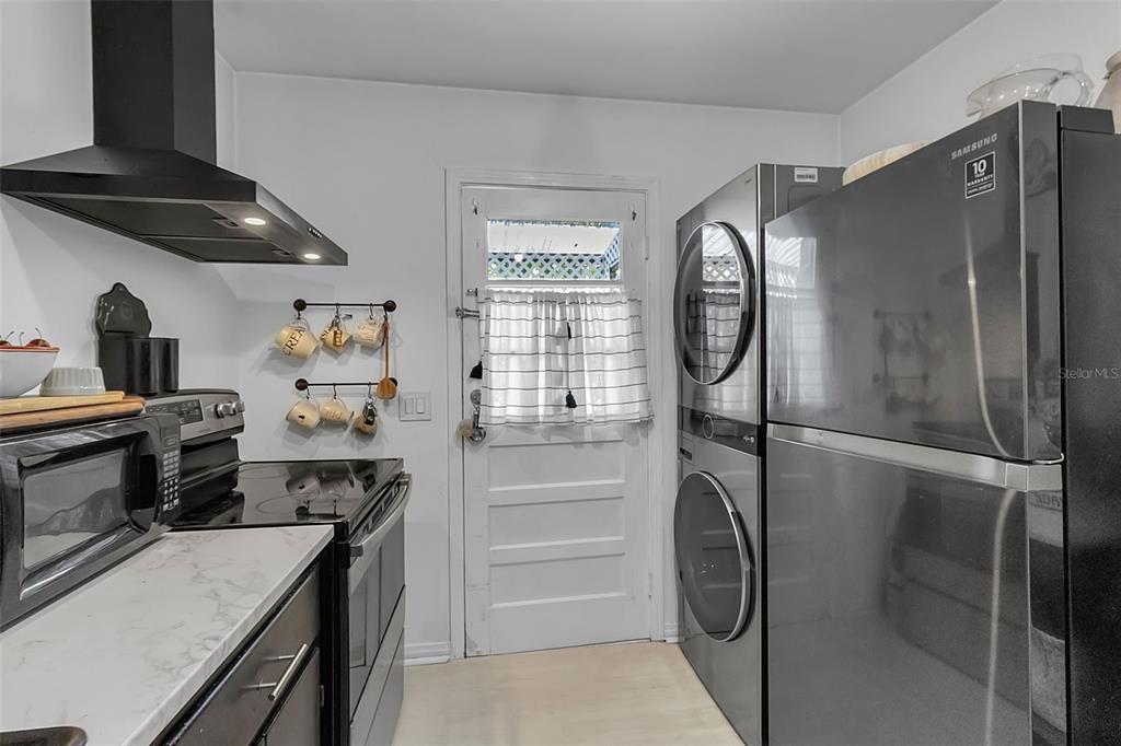 2562 Ashton Road Sarasota, FL 34231 - Photo 18 of 30 a kitchen with a refrigerator and a stove top oven