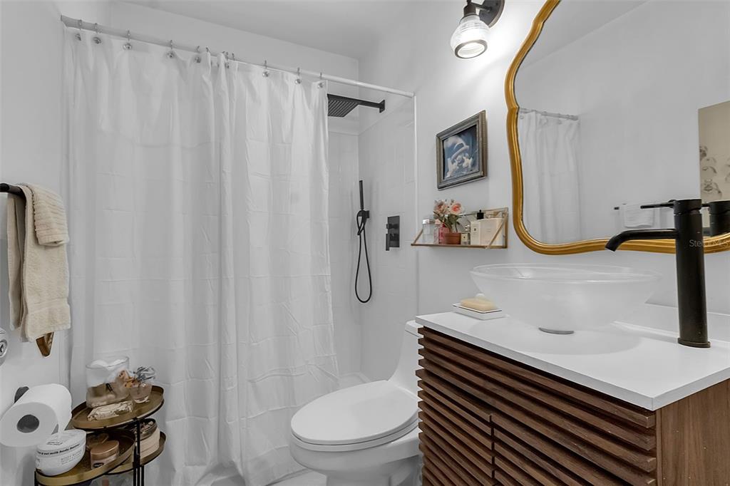 2562 Ashton Road Sarasota, FL 34231 - Photo 21 of 30 a bathroom with a sink toilet and shower