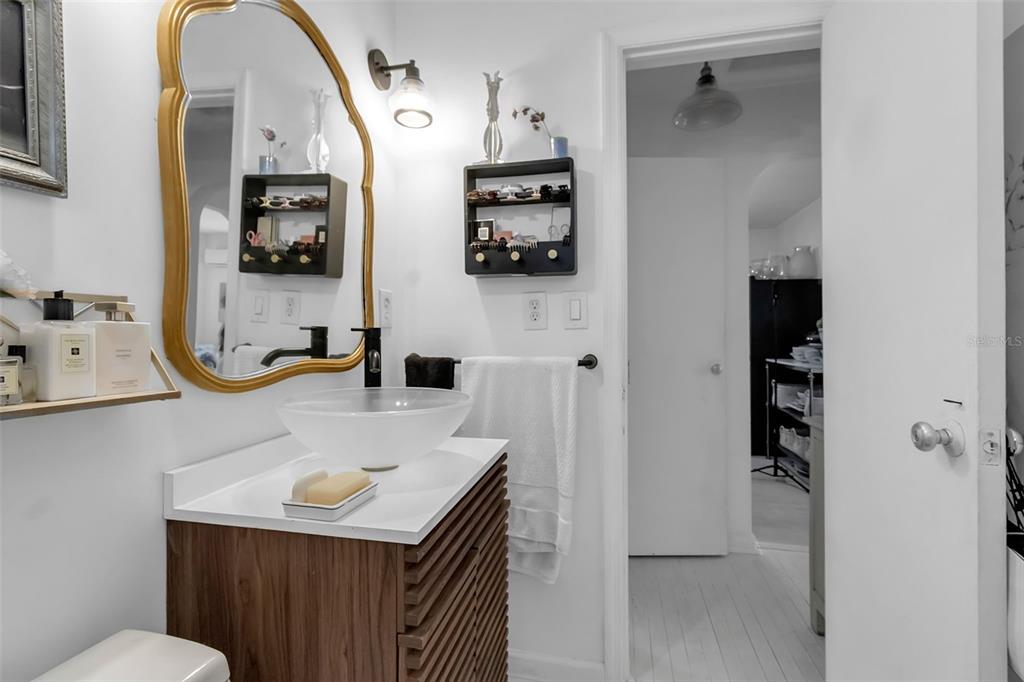 2562 Ashton Road Sarasota, FL 34231 - Photo 22 of 30 a bathroom with a sink a toilet and mirror