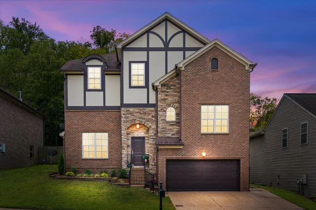 a front view of a house with a yard and garage