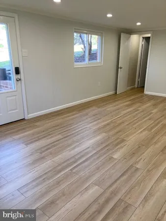 an empty room with wooden floor and fireplace