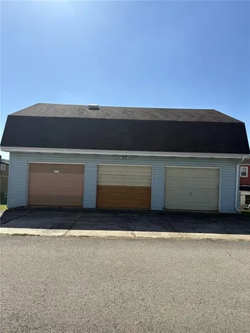 a view of an empty room and kitchen