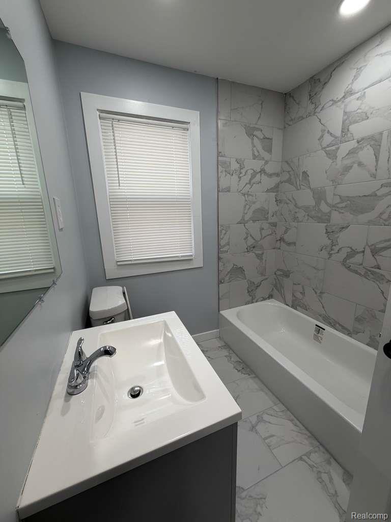 7416 Heyden Detroit, MI 48228 - Photo 11 of 16 Full bathroom featuring vanity, light marble finish flooring, shower / washtub combination, and recessed lighting