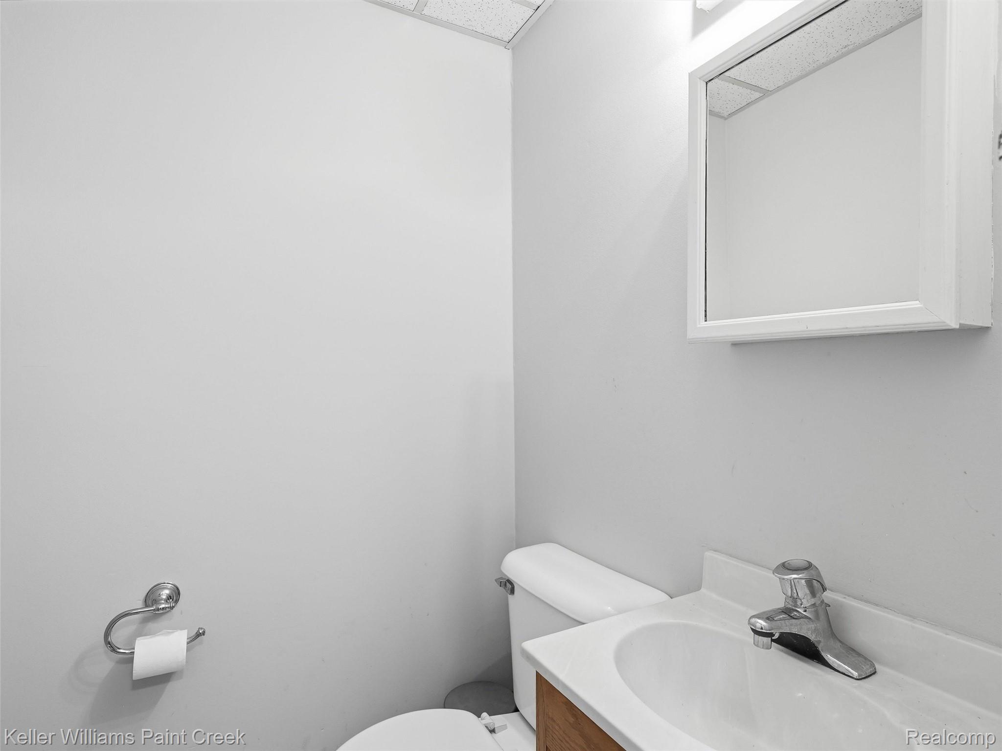 1208 Lear Court Rochester, MI 48307 - Photo 18 of 28 White vanity with an integrated sink and chrome faucet