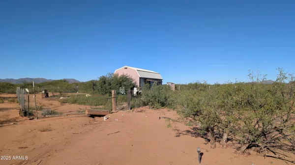 a view of a small house with a yard