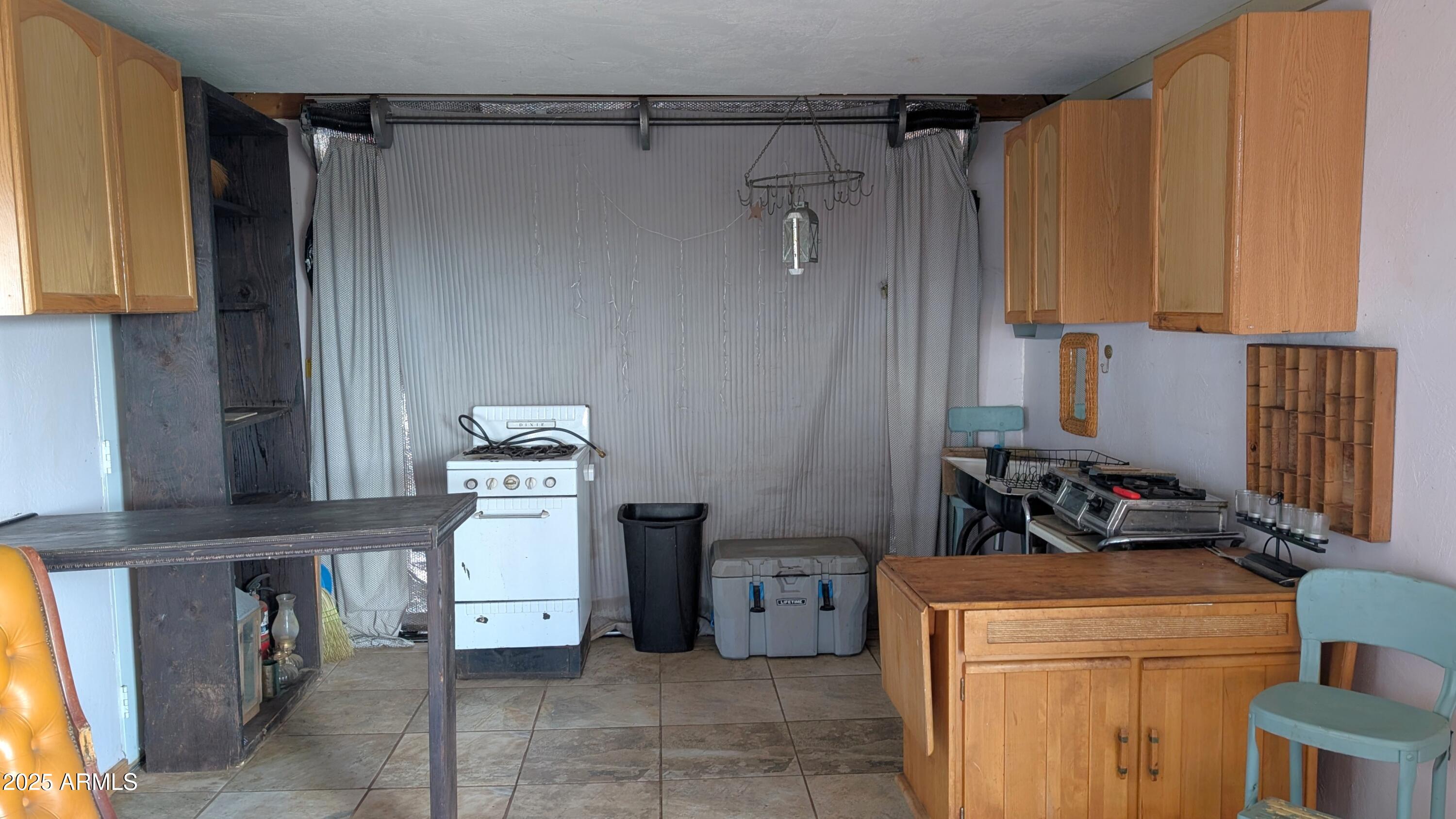 Tbd North Westward Trail, Unit 9 McNeal, AZ 85617 - Photo 27 of 37 a kitchen with a refrigerator and cabinets