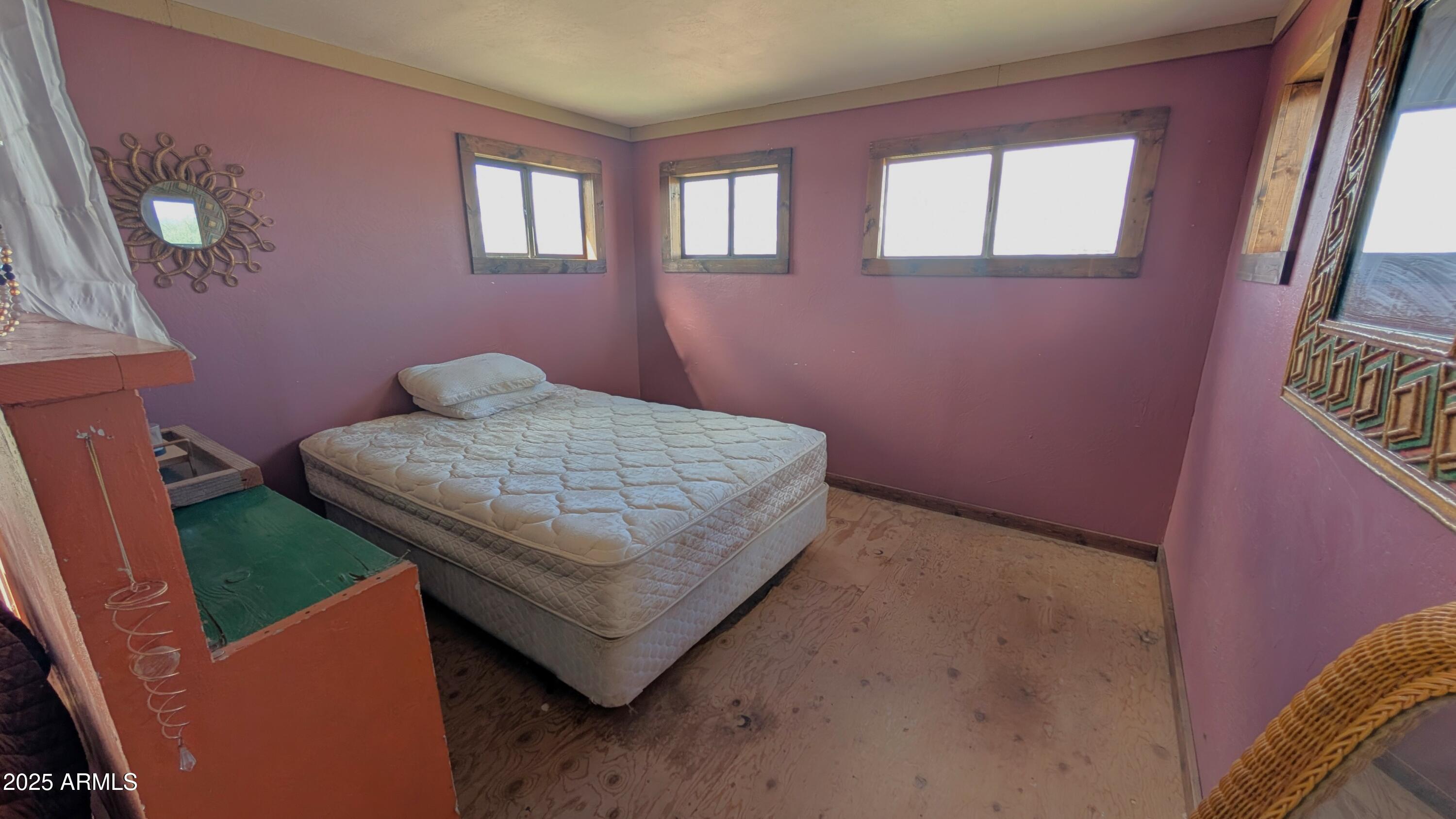 Tbd North Westward Trail, Unit 9 McNeal, AZ 85617 - Photo 32 of 37 a bedroom with a bed and wooden floor
