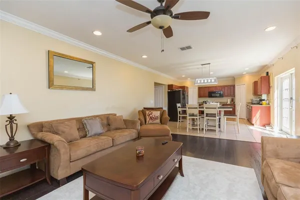 a living room with furniture and kitchen view