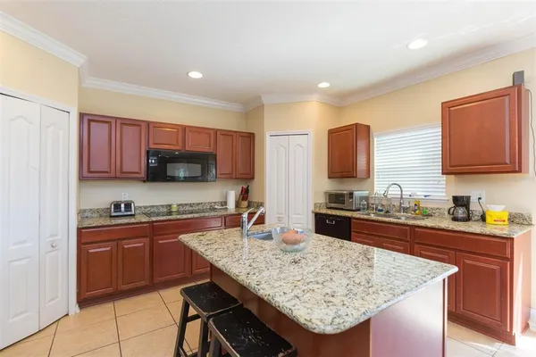 a kitchen with stainless steel appliances granite countertop wooden cabinets a sink and dishwasher