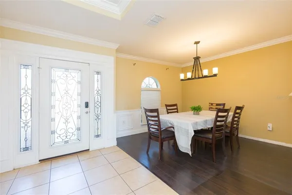a view of a dining room with furniture and wooden floor