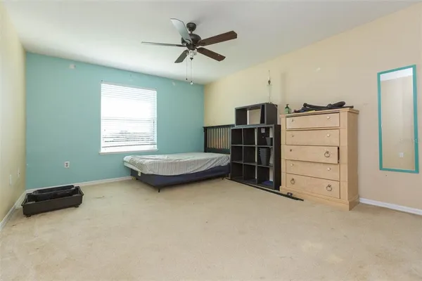 a view of a livingroom with furniture and a ceiling fan