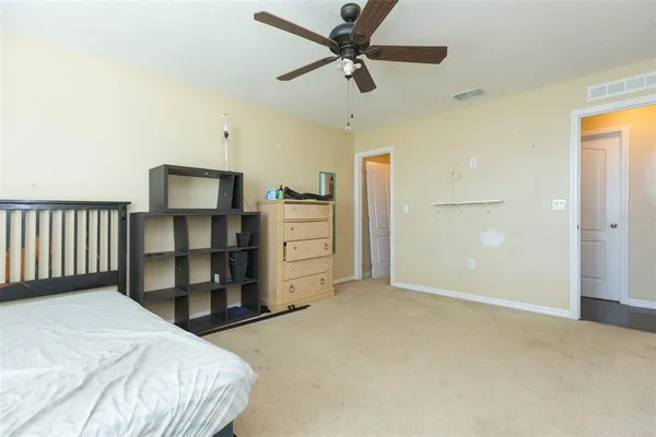 a bedroom with a bed and cabinets
