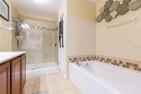 a spacious bathroom with a bathtub and shower