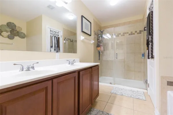 a bathroom with a granite countertop sink mirror and shower