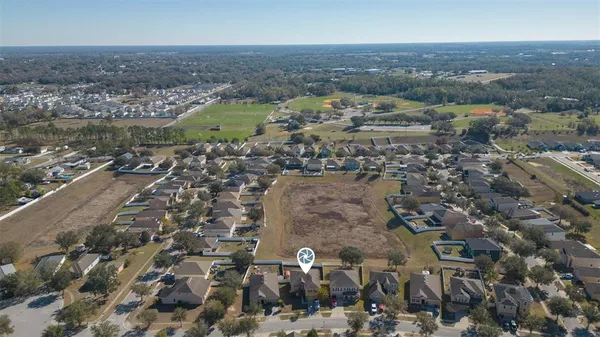 an aerial view of residential houses with outdoor space