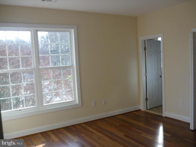 5224 Inverchapel Road Springfield, VA 22151 - Photo 12 of 30 an empty room with wooden floor and windows