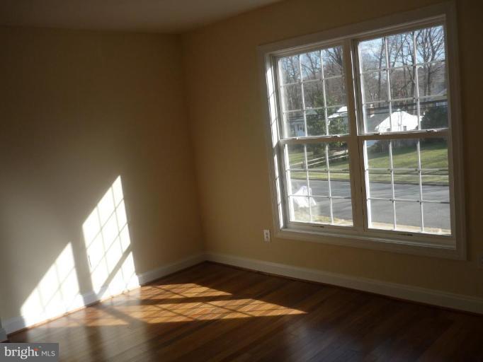 5224 Inverchapel Road Springfield, VA 22151 - Photo 15 of 30 a view of empty room with wooden floor and fan