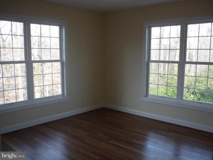 5224 Inverchapel Road Springfield, VA 22151 - Photo 16 of 30 an empty room with wooden floor and windows