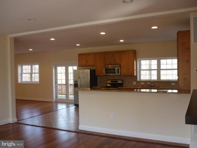 5224 Inverchapel Road Springfield, VA 22151 - Photo 22 of 30 a kitchen with stainless steel appliances a refrigerator sink and stove