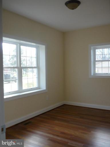 5224 Inverchapel Road Springfield, VA 22151 - Photo 25 of 30 an empty room with wooden floor and windows
