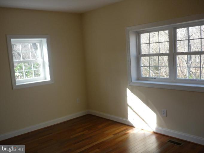 5224 Inverchapel Road Springfield, VA 22151 - Photo 28 of 30 an empty room with wooden floor and windows
