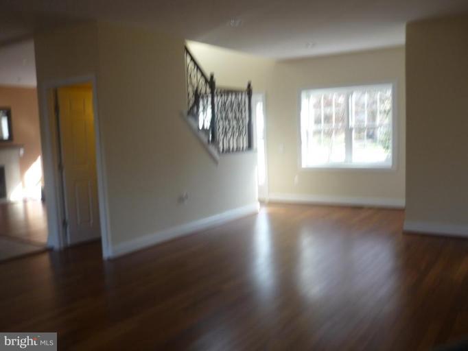 5224 Inverchapel Road Springfield, VA 22151 - Photo 7 of 30 an empty room with wooden floor and windows